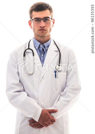 Portrait of hero in white coat. Cheerful smiling young doctor with stethoscope in medical hospital standing against white background. Coronavirus covid-19 danger alert 96135393