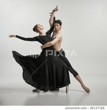 Young man and woman, ballet dancers performing isolated over grey studio background Tenderness and passion Young man and woman, ballet dancers performing isolated over grey studio background Tenderness and passion 96137166