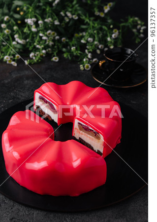 Multi layered raspberry mousse cake on plate 96137357