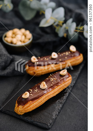 french eclairs with chocolate and hazelnuts 96137360
