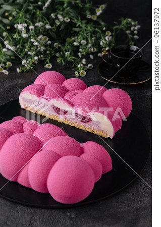 Contemporary raspberry mousse cake on black plate Contemporary raspberry mousse cake on black plate 96137972