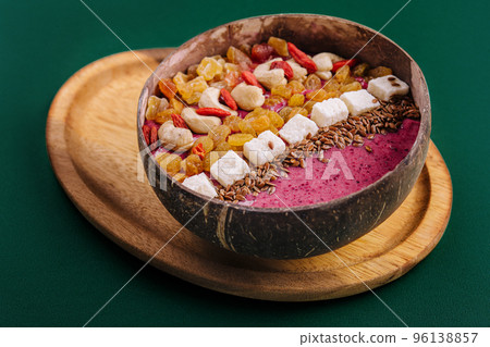 Healthy breakfast raisins and cashew nuts smoothie in coconut bowl Healthy breakfast raisins and cashew nuts smoothie in coconut bowl 96138857