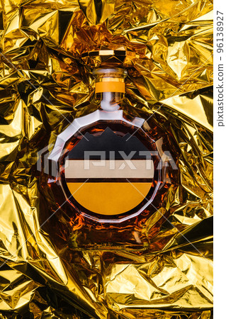 bottle of cognac on gold foil 96138927