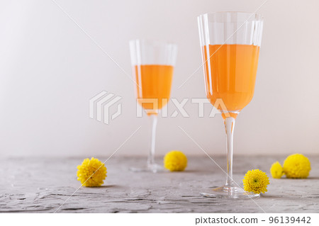 Mimosa alcohol cocktail with orange juice and dry champagne Mimosa alcohol cocktail with orange juice and dry champagne 96139442