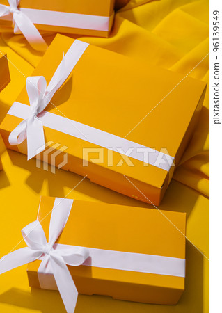 Yellow gifts on a yellow background Yellow gifts on a yellow background 96139549