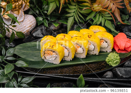 Cheese sushi rolls on the black plate 96139851