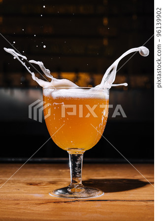 Glass of splashing beer close up 96139902