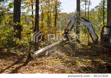 Landscaping work to clear land roots as part of housing development subdivision, using tractors skid steers. Landscaping work to clear land roots as part of housing development subdivision, using tractors skid steers. 96141606