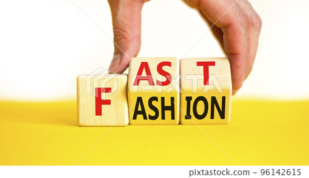 Fast fashion symbol. Concept words Fast fashion on wooden cubes. Beautiful yellow table white background. Businessman hand. Business fast fashion concept. Copy space. 96142615