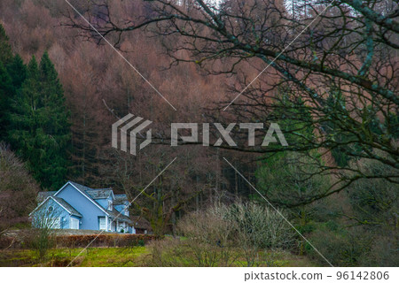 Blue house alone in the middle of the mountain forest. Blue house alone in the middle of the mountain forest. 96142806