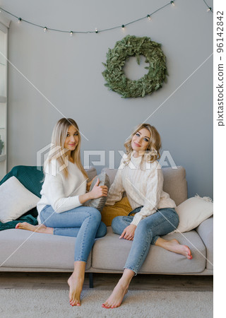 Happy friends or sisters are ready to celebrate Christmas and New Year at home Happy friends or sisters are ready to celebrate Christmas and New Year at home 96142842