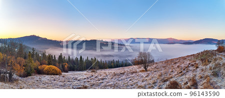 Mountain autumn misty Sunrise panorama. Majestic Morning fog, November Valley Aerial scene. Ice, frost on grass. Fall sunny Landscape, forest hills. Beautiful tonal perspective 96143590