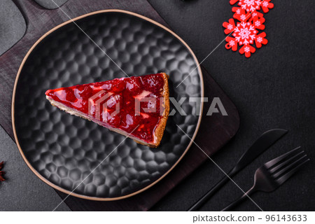 Homemade tasty cheesecake with jelly and raspberry berries on a black plate Homemade tasty cheesecake with jelly and raspberry berries on a black plate 96143633