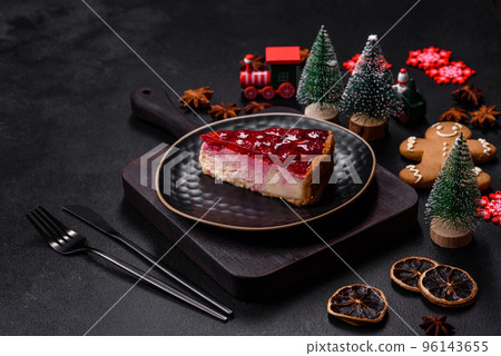 Homemade tasty cheesecake with jelly and raspberry berries on a black plate Homemade tasty cheesecake with jelly and raspberry berries on a black plate 96143655