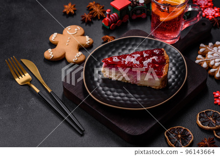 Homemade tasty cheesecake with jelly and raspberry berries on a black plate Homemade tasty cheesecake with jelly and raspberry berries on a black plate 96143664