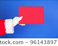 Hand in costume Santa Claus is holding envelope. Merry Christmas, New Year's Eve concept. isolated on blue background 96143897