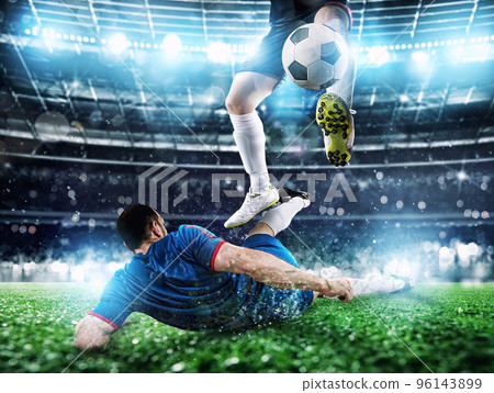 Soccer players with soccerball at the stadium during the match 96143899