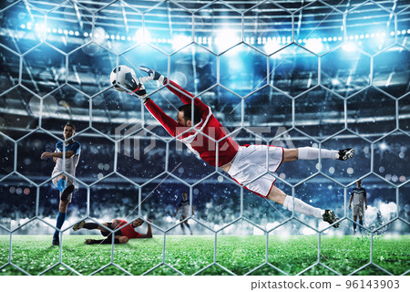 Goalkeeper catches the ball in the stadium during a football game. Goalkeeper catches the ball in the stadium during a football game. 96143903