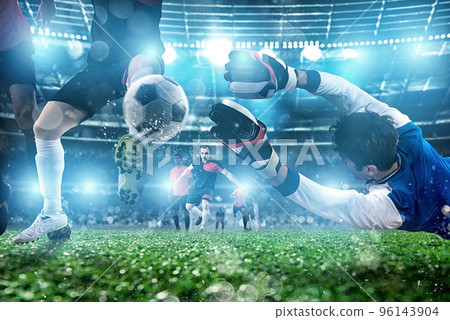 Goalkeeper catches the ball in the stadium during a football game. Goalkeeper catches the ball in the stadium during a football game. 96143904