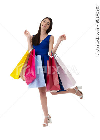 Happy woman with shopping bags in hand. Isolated on white background. 96143907