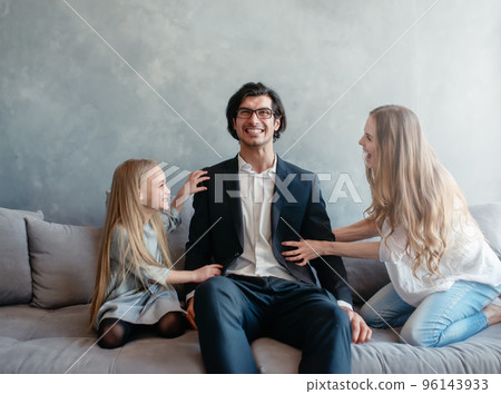 Happy little girl play with her mother and father 96143933