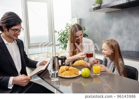 Happy family have a breakfast at home Happy family have a breakfast at home 96143986