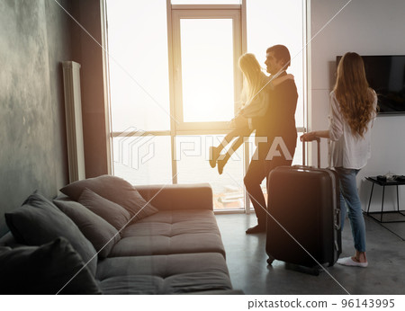 Father comes back to home from a travel Father comes back to home from a travel 96143995
