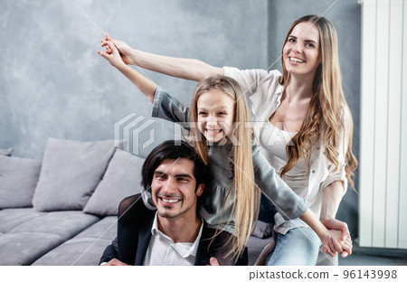 Happy little girl play with her mother and father Happy little girl play with her mother and father 96143998