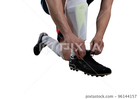 Football player adjust his shoes before the match. Isolated on white background 96144157