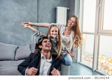 Happy little girl play with her mother and father 96144244