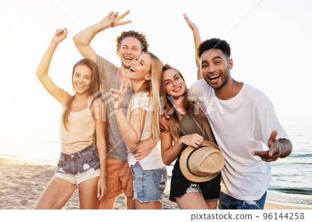 Group of friends having fun on the beach. Concept of summertime Group of friends having fun on the beach. Concept of summertime 96144258