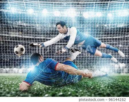 Goalkeeper catches the ball in the stadium during a football game. 96144282