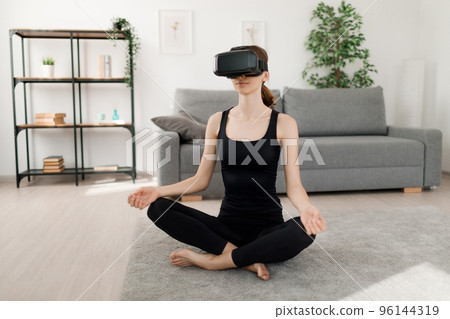 Woman training in VR goggles 96144319