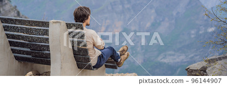 BANNER, LONG FORMAT Man tourist on background of Breathtaking panoramic view of the Grlo Sokolovo gorge in Montenegro. In the foreground is a mountain, the flat side of which forms a cliff, and the 96144907