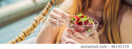 Portrait of gorgeous woman wearing beautiful dress sitting in a patio and eating strawberry BANNER, LONG FORMAT Portrait of gorgeous woman wearing beautiful dress sitting in a patio and eating strawberry BANNER, LONG FORMAT 96145159