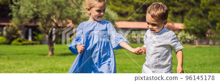 Cute little children on green grass in park Portrait of a disgruntled girl sitting at a cafe table BANNER, LONG FORMAT 96145178