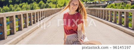 BANNER, LONG FORMAT Montenegro. Woman tourist in background of Dzhurdzhevich Bridge Over The River Tara. Travel around Montenegro concept. Sights of Montenegro Portrait of a disgruntled girl sitting 96145197
