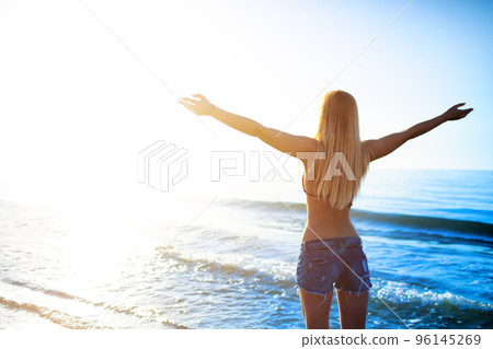 Freedom girl at the beach in a sunny day Freedom girl at the beach in a sunny day 96145269