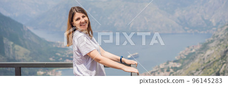 BANNER, LONG FORMAT Woman tourist enjoys the view of Kotor. Montenegro. Bay of Kotor, Gulf of Kotor, Boka Kotorska and walled old city. Travel to Montenegro concept. Fortifications of Kotor is on BANNER, LONG FORMAT Woman tourist enjoys the view of Kotor. Montenegro. Bay of Kotor, Gulf of Kotor, Boka Kotorska and walled old city. Travel to Montenegro concept. Fortifications of Kotor is on 96145283