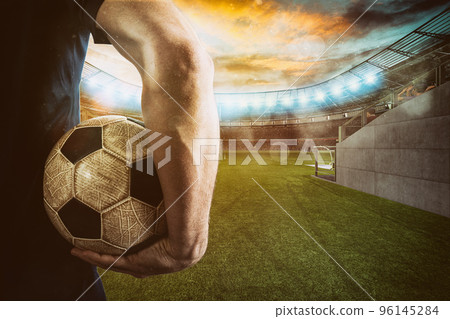 Soccer player ready to play with ball in his hands at the exit of the locker room tunnel 96145284
