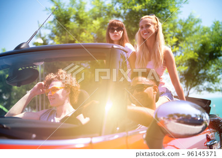 Young friends ready to travel by the car Young friends ready to travel by the car 96145371