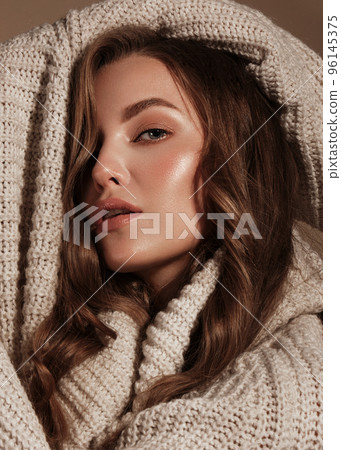 Beautiful young girl with gentle make-up in warm sweater and long straight hair. Beauty face. Beautiful young girl with gentle make-up in warm sweater and long straight hair. Beauty face. 96145375