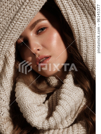 Beautiful young girl with gentle make-up in warm sweater and long straight hair. Beauty face. Beautiful young girl with gentle make-up in warm sweater and long straight hair. Beauty face. 96145377