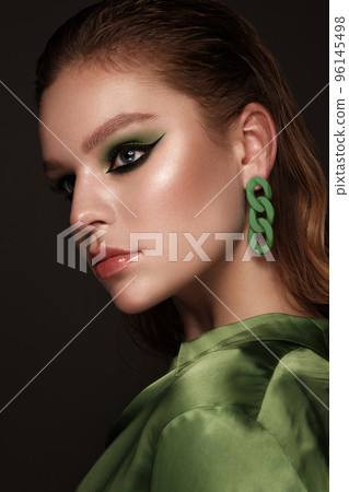 Beautiful sexy woman with classic make-up, fashion hair and green eyes. Beauty face. Photo taken in the studio. Beautiful sexy woman with classic make-up, fashion hair and green eyes. Beauty face. Photo taken in the studio. 96145498