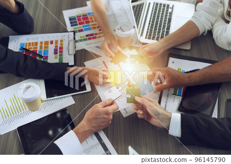 Teamwork of partners. Concept of integration and startup with puzzle pieces Teamwork of partners. Concept of integration and startup with puzzle pieces 96145790