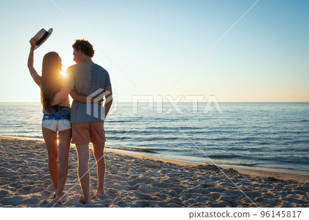 young couples during sunrise at the beach 96145817