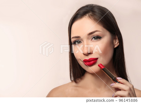 Beautiful woman with red lipstick on light background, space for text Beautiful woman with red lipstick on light background, space for text 96145886