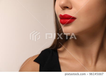 Beautiful woman with red lipstick on light background, closeup. Space for text Beautiful woman with red lipstick on light background, closeup. Space for text 96145887