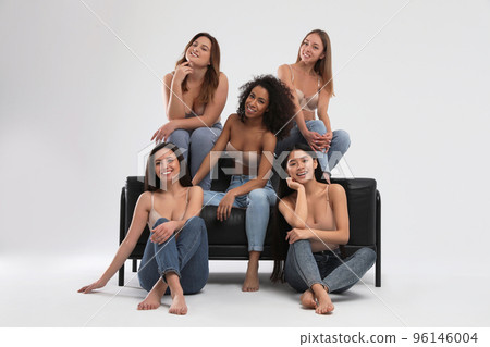 Group of women with different body types in jeans and underwear on light background Group of women with different body types in jeans and underwear on light background 96146004