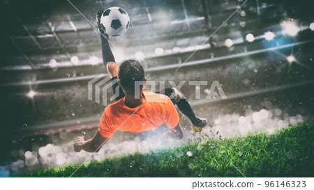 Football scene at night match with player ready to shoot the ball 96146323